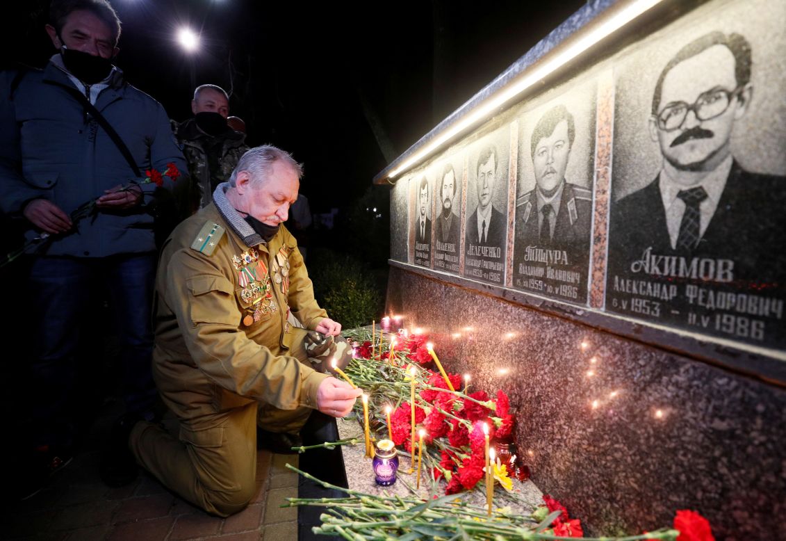A man in Slavutych, Ukraine, lights a candle Monday, April 26, at a memorial dedicated to firefighters and workers who died after the Chernobyl nuclear disaster. It was the 35th anniversary of the disaster.