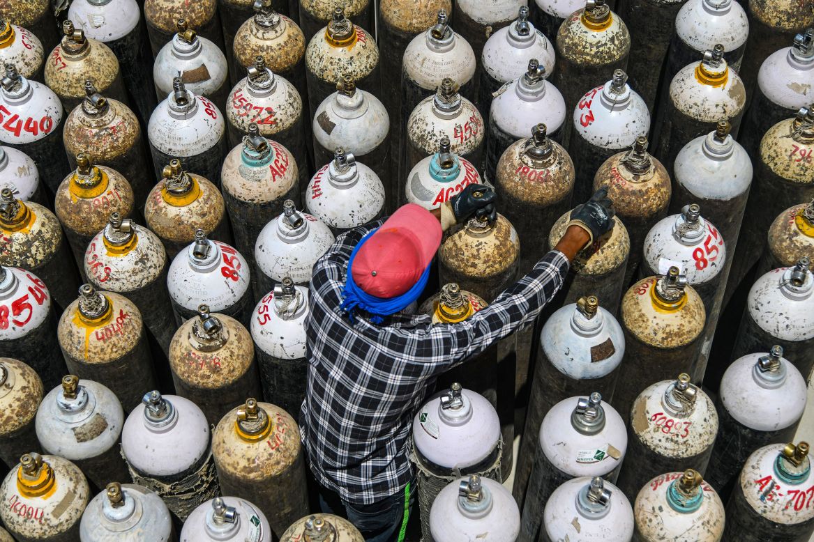 A worker sorts oxygen cylinders for Covid-19 patients at a hospital facility in Ajmer, India, on Friday, April 23. Some medical facilities in India <a href="https://www.cnn.com/2021/04/26/india/gallery/india-coronavirus-crisis/index.html" target="_blank">have started to run out of oxygen, ventilators and intensive-care beds.</a>