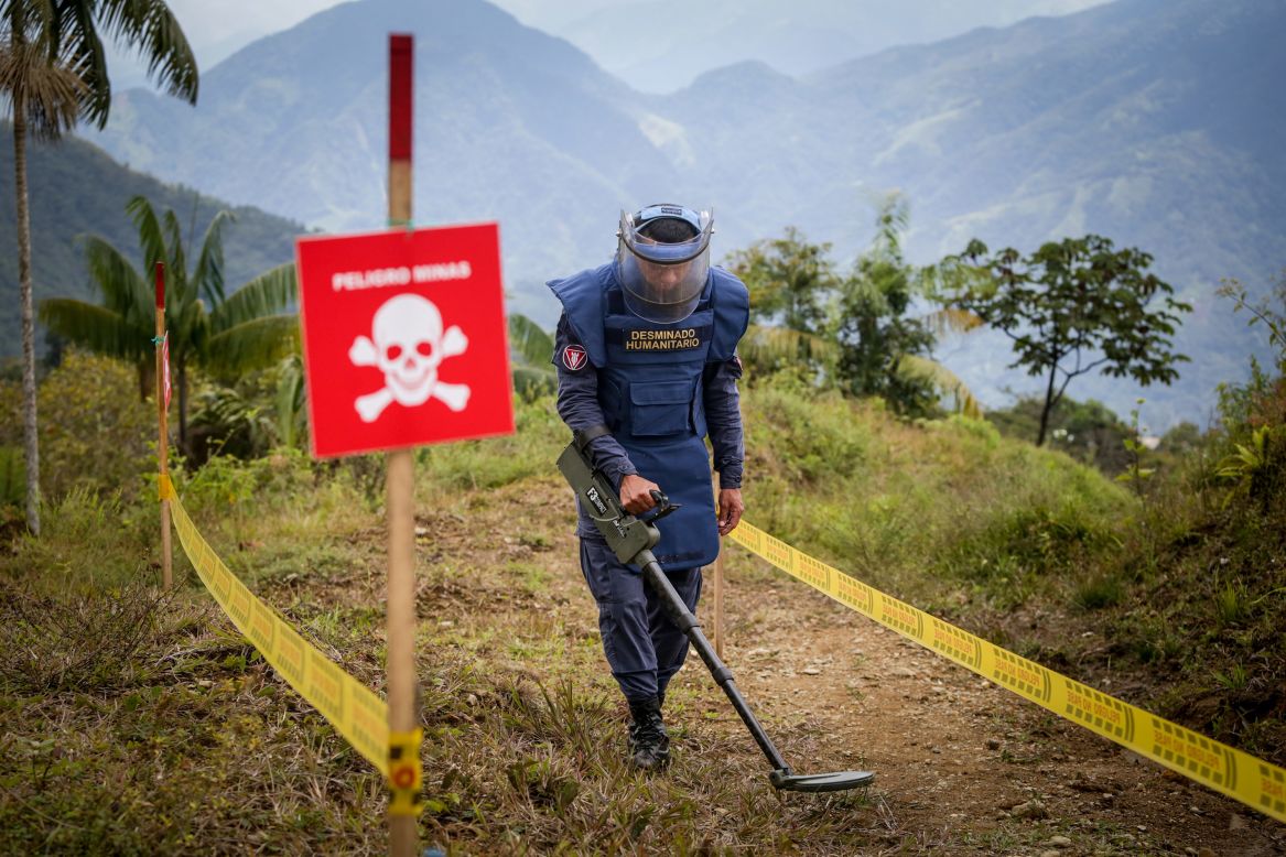 A member of the Colombian Nation Army demonstrates how to detect landmines inside the village of El Congal on Monday, April 26. Families were able to return to the village after the area was declared to be 99% free of anti-personnel mines.