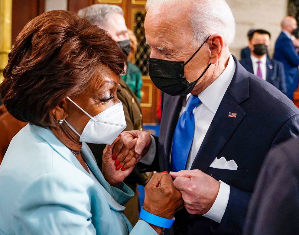 US President Joe Biden fist-bumps US Rep. Maxine Waters after his speech to a joint session of Congress on Wednesday, April 28.