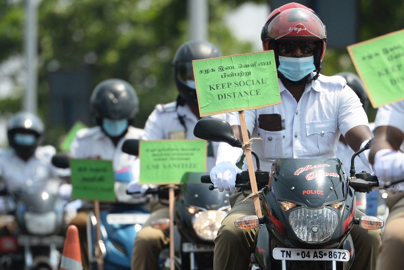 Police personnel hold placards on their motorbikes during a Covid-19 awareness rally in Chennai on April 29.