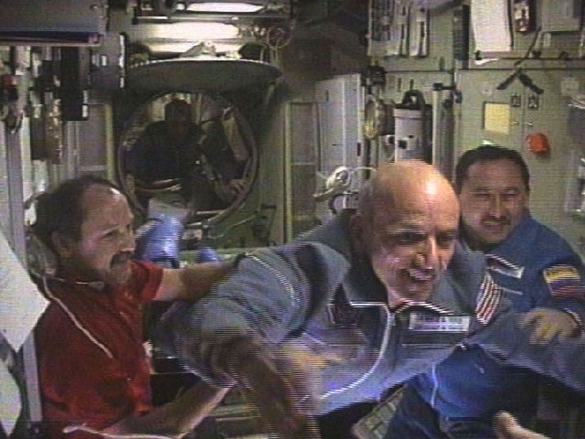<strong>Two decades on: </strong>It's been 20 years since Dennis Tito, the world's first space tourist, pictured here flying into the ISS, went to space. Only a handful of people have followed in Tito's footsteps, but companies like SpaceX and Virgin Galactic reckon space tourism is the future.