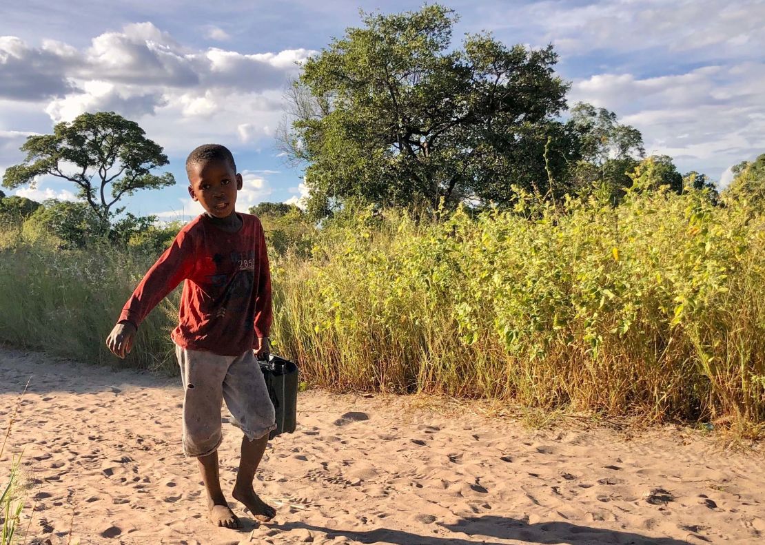 In the San village, children carry water from a nearby borehole. Activists and scientists fear that a large-scale oil industry here could pollute the ground water. ReconAfrica says their practices won't lead to water pollution.