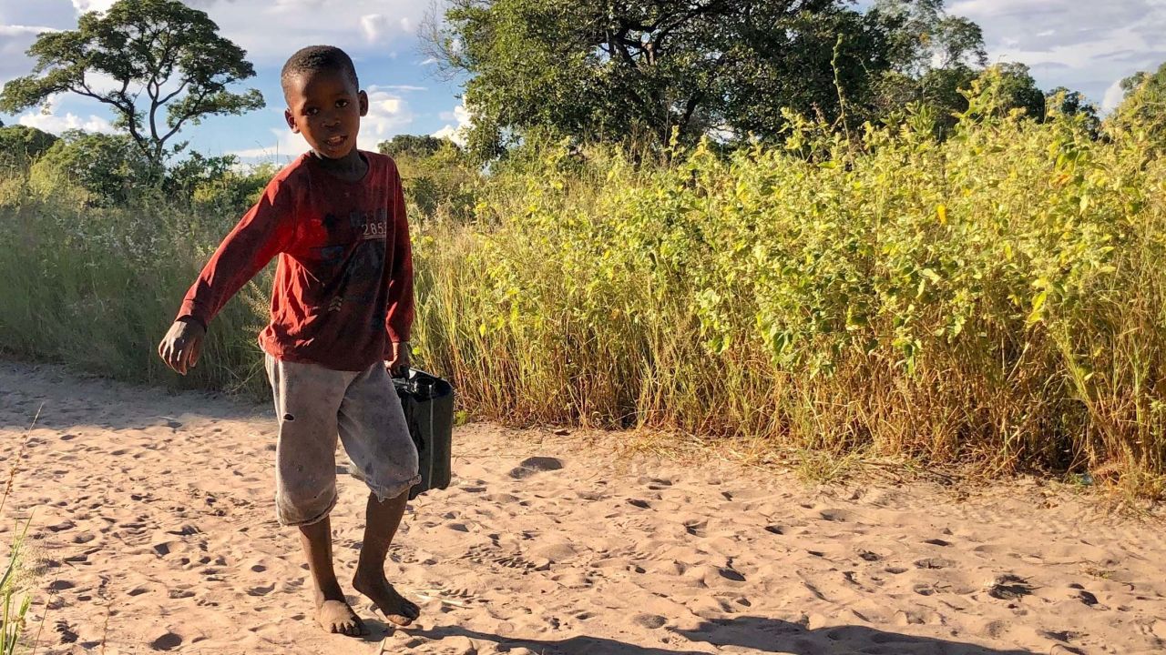In the San village, children carry water from a nearby borehole. Activists and scientists fear that a large-scale oil industry here could pollute the ground water. ReconAfrica says their practices won't lead to water pollution.