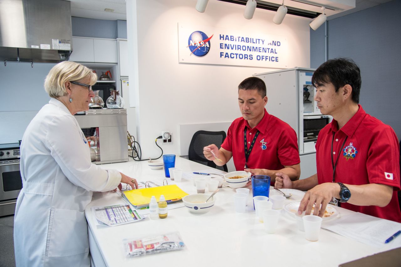 NASA astronaut Kjell Lindgren (center) and Japan Aerospace Exploration Agency astronaut Kimiya Yui (right), both Expedition 44/45 flight engineers, participate in a food tasting at NASA's Johnson Space Center in Houston, July 10, 2014.