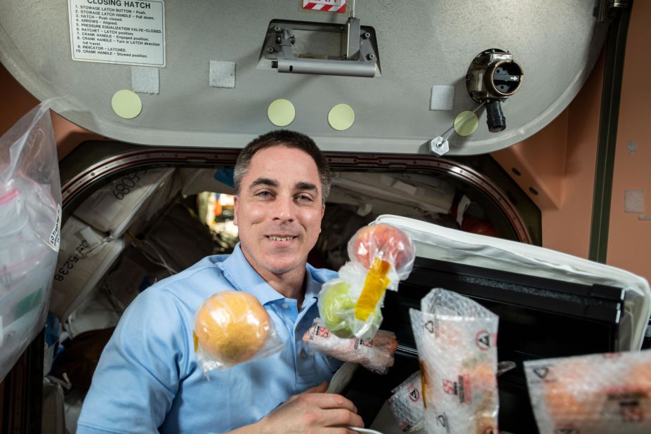 NASA astronaut and Expedition 63 Commander Chris Cassidy unpacks fresh fruit and other food items shipped aboard the Northrop Grumman Cygnus space freighter to the International Space Station, October 5, 2020.
