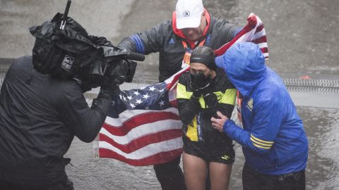 Linden celebrates after crossing the finish line at the 2018 Boston Marathon.