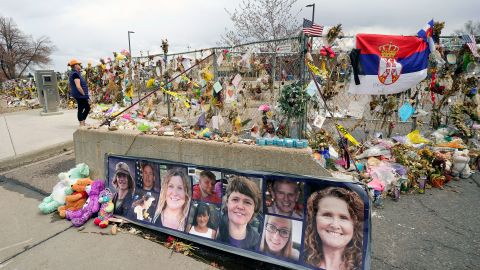 In this Friday, April 23, 2021, file photo, photographs of the 10 victims of a mass shooting in a King Soopers grocery store are posted on a cement barrier outside the supermarket in Boulder, Colo.