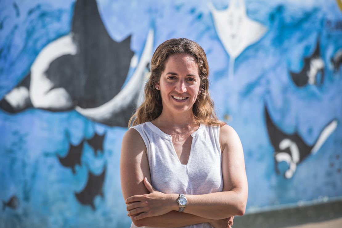 Forsberg photographed in front of a mural of manta rays, painted by local kids.