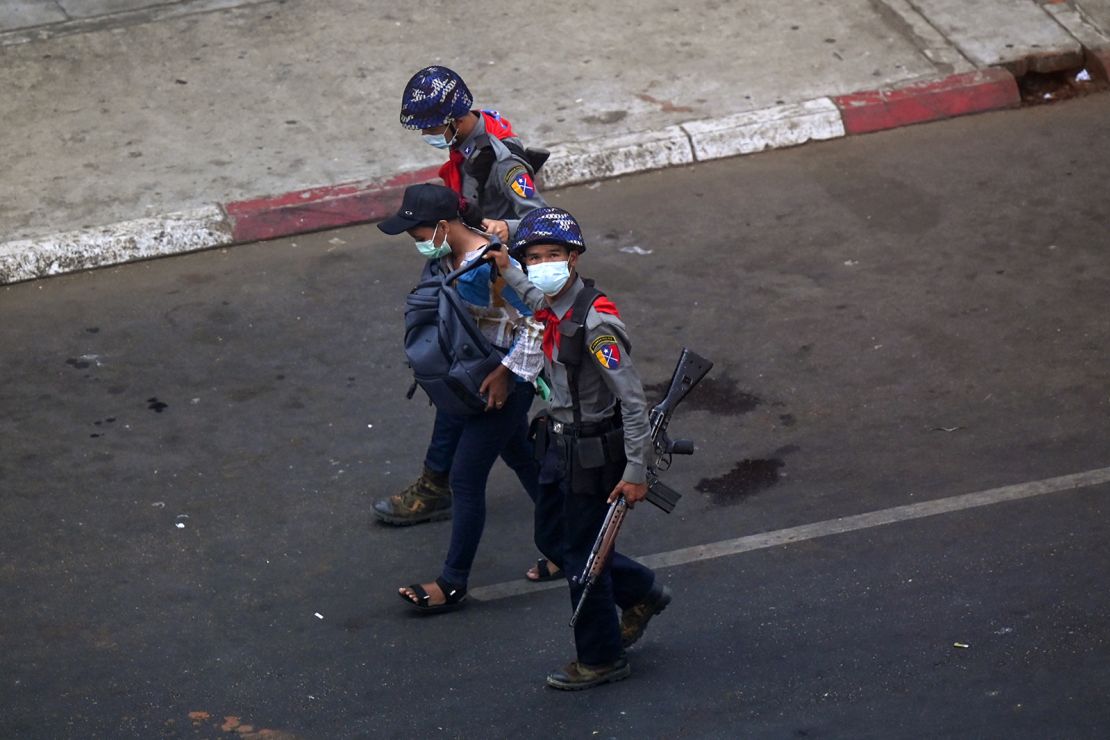 Police arrest Myanmar Now journalist Kay Zon Nwe in Yangon on February 27, as protesters were taking part in a demonstration against the military coup.