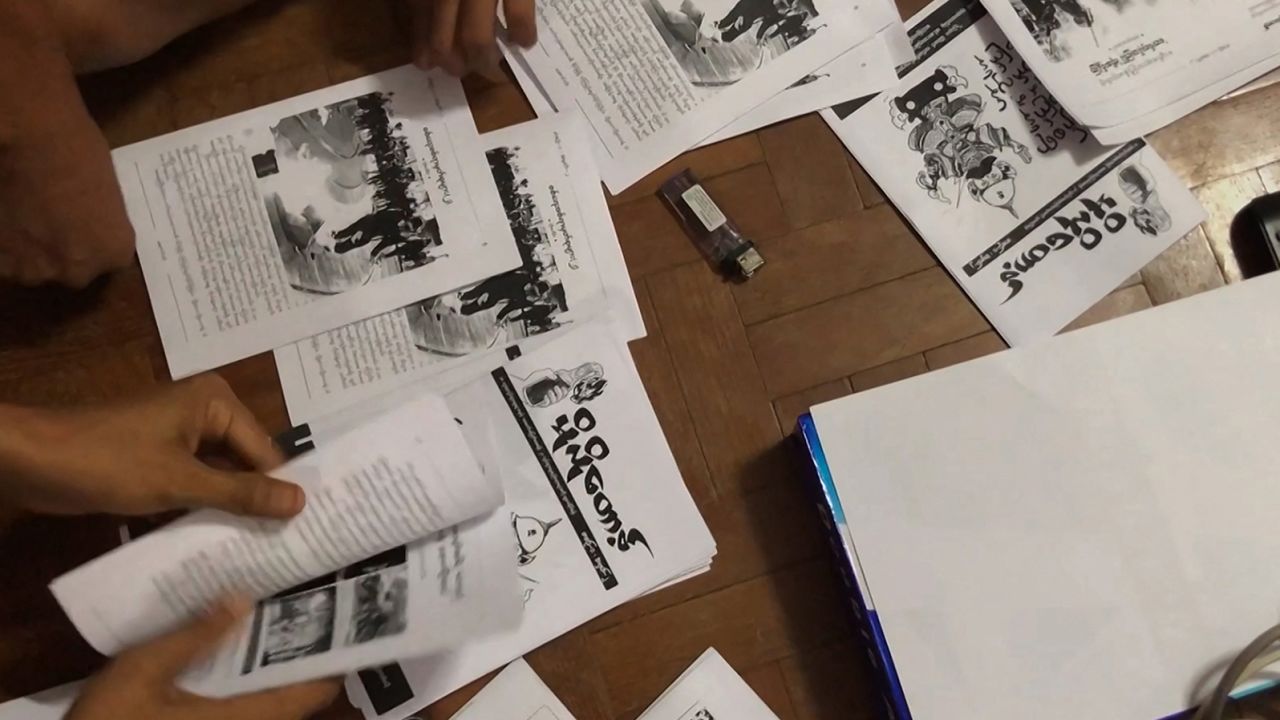 This screengrab provided via AFPTV video footage taken on April 10, 2021 shows an underground newsletter being produced to spread information in Yangon.