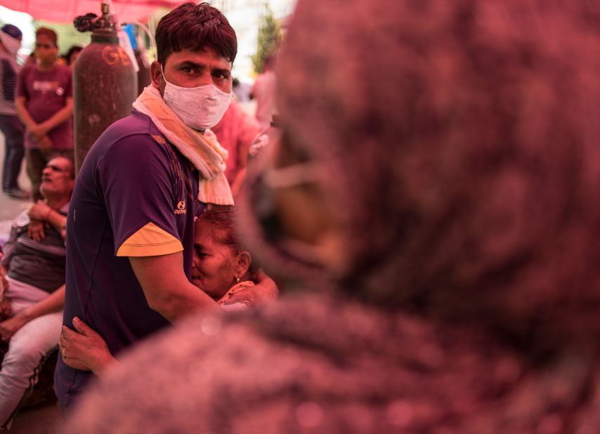 A woman hugs her son after arriving to receive free oxygen in New Delhi on May 1.