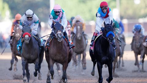 Medina Spirit, ridden by jockey John Velazquez, right, crosses the finish line at the 147th running of the Kentucky Derby at Churchill Downs on May 01, 2021 in Louisville, Kentucky.