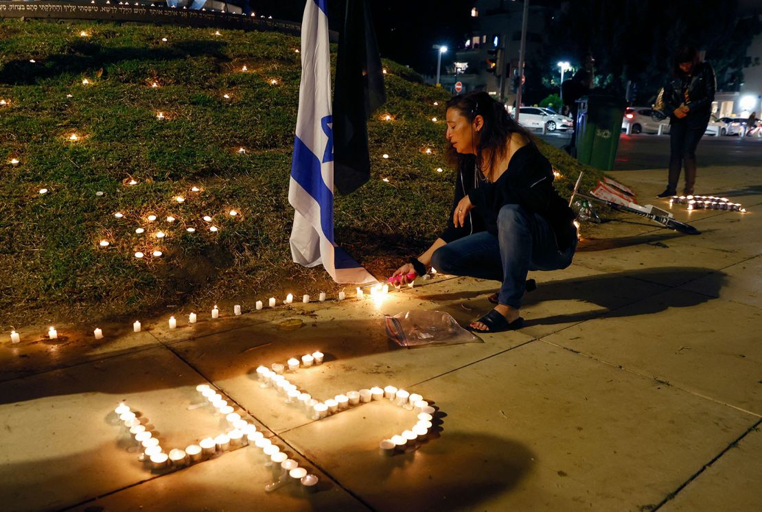 People light candles during a vigil in Habima Square in the Israeli coastal city of Tel Aviv on May 1, 2021.