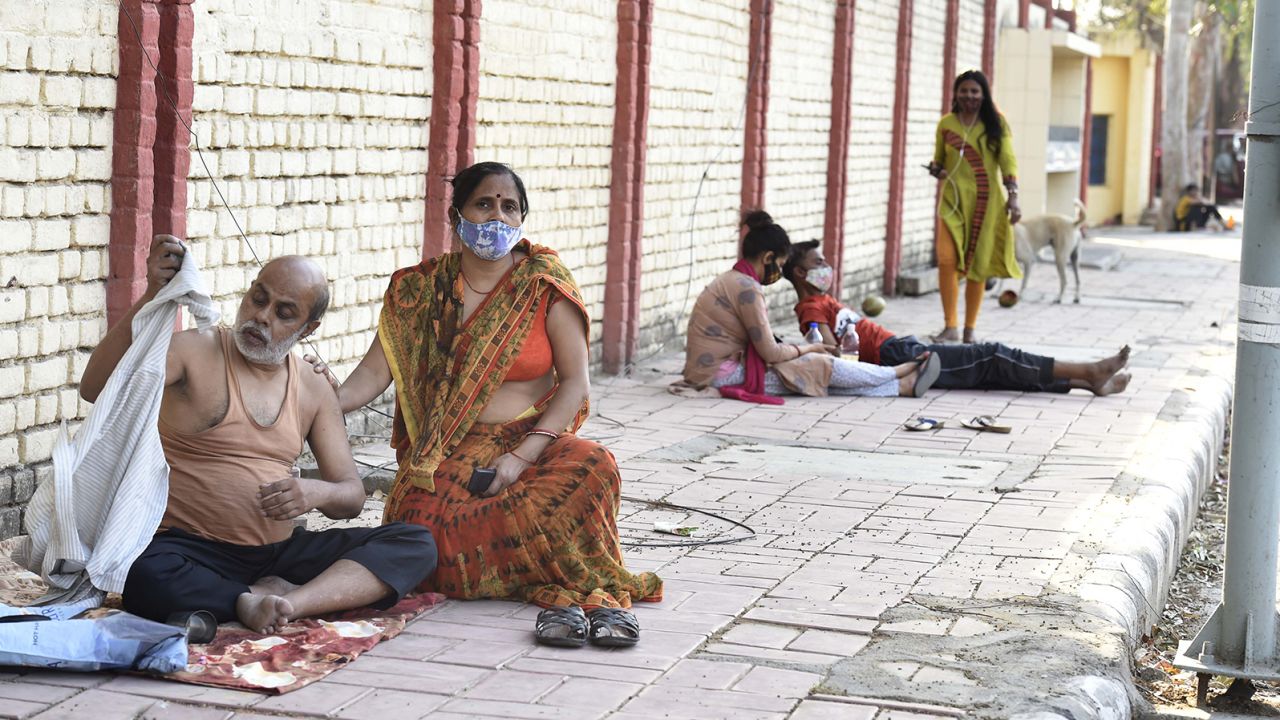 Covid-19 patients wait outside Sardar Patel Covid Care Centre, in New Delhi, on April 25.
