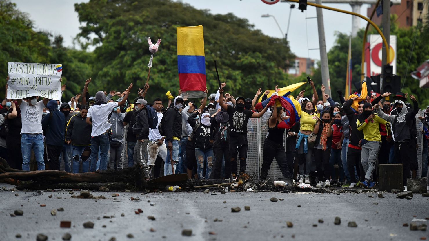 Demonstrators shout towards riot police officers during clashes in Cali, Colombia, on April 30, 2021. 