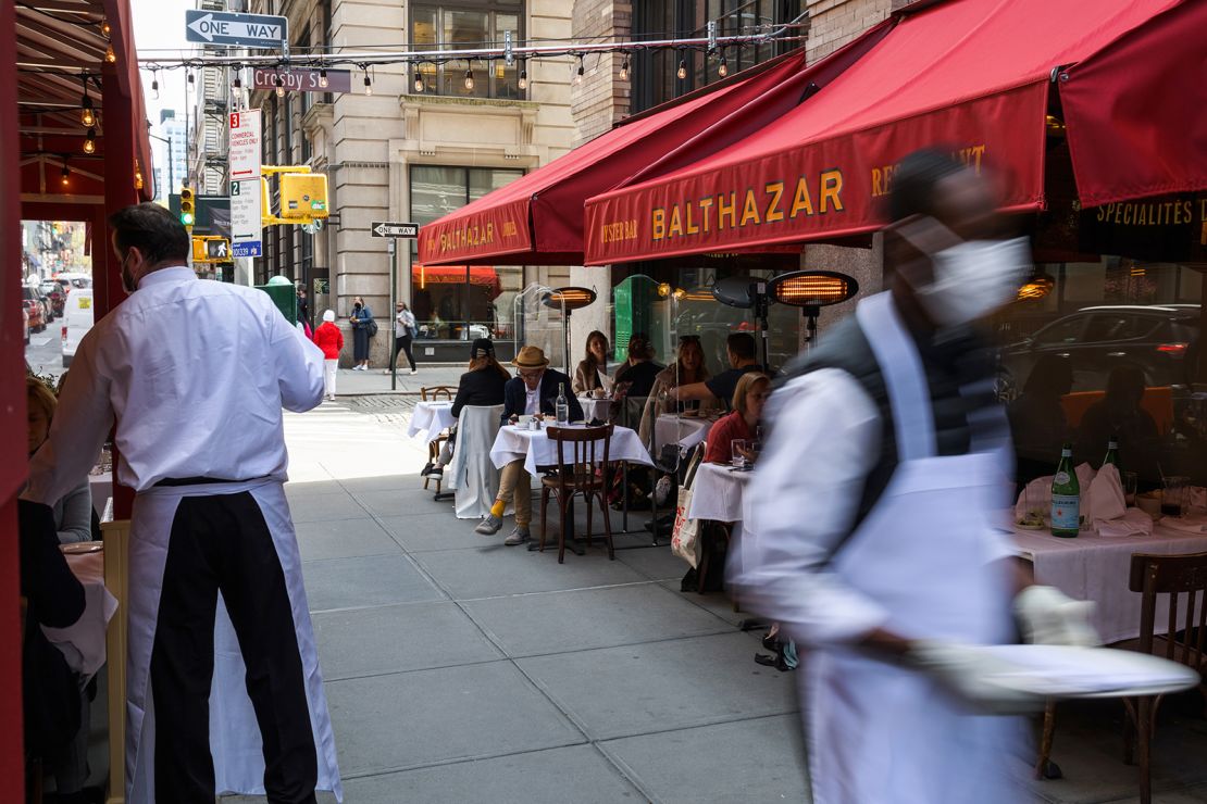 Customers dine on an outdoor patio in New York on April 27, 2021