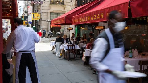 Customers dine on an outdoor patio in New York on April 27, 2021