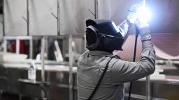 JBS Greeley Beef Plant welder Guillermo Rivera welds an individual frock hook at each meat processing station that also includes new sheet-metal partitions at each station April 23, 2020. Over 100 employees tested positive for the disease, three plant employees have died, and one (non-plant) JBS corporate employee also passed away. 