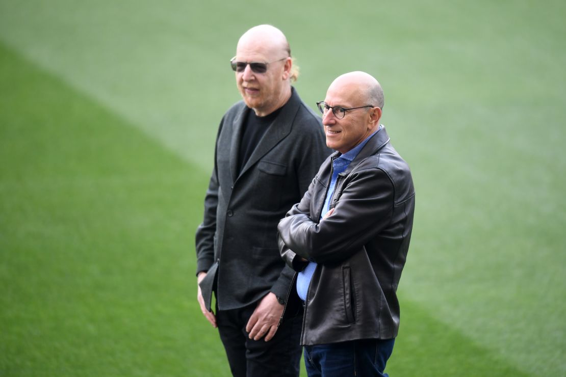 Joel and Avram Glazer looks on as they attend a training session.
