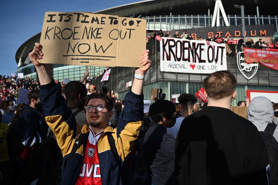 Arsenal fans hold placards during a protest against the club's owner Stan Kroenke.