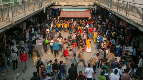 Nepali people arrive at a crowded bus station to buy bus tickets to go back to their villages a day prior to lockdown in Kathmandu, Nepal, on April 28, 2021. 