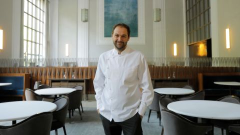 Chef and owner Daniel Humm poses for a portrait in the shuttered dining room of Michelin-starred restaurant Eleven Madison Park in New York. Humm has now announced the acclaimed restaurant will officially reopen with a fully plant-based menu.