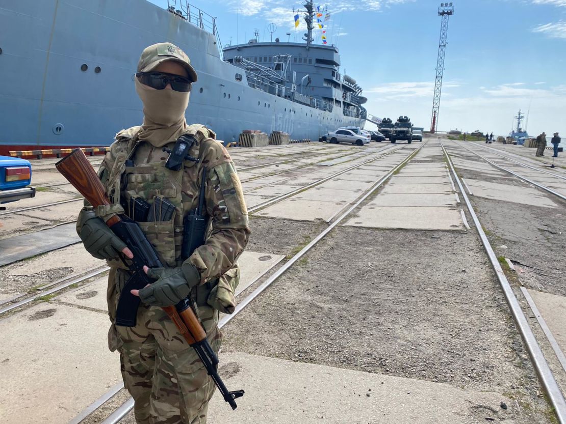 A Ukrainian marine stands guard in the port of Mariupol.