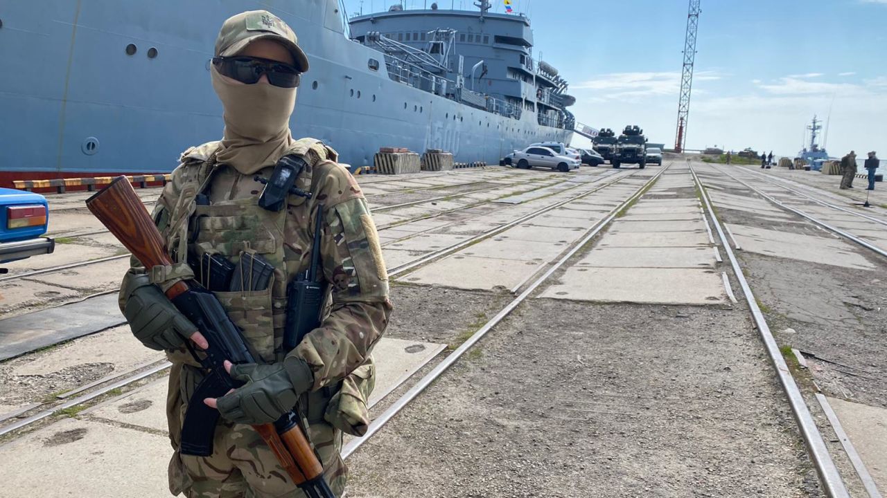 A Ukrainian marine stands guard in the port of Mariupol.