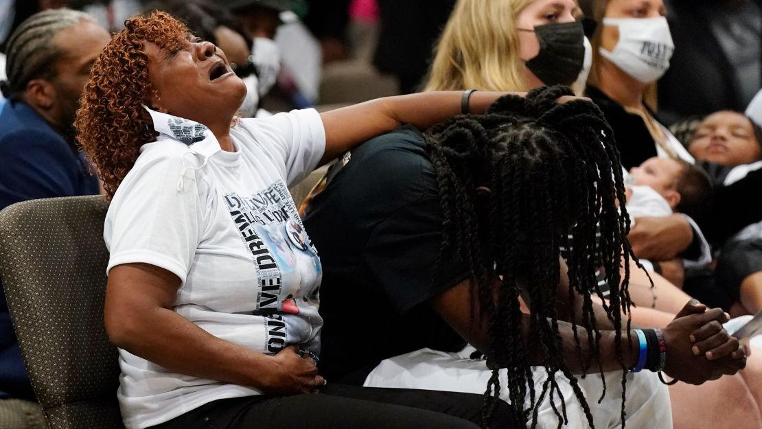 Family members react during Brown's funeral on Monday.