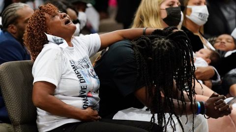 Family members react during Brown's funeral on Monday.