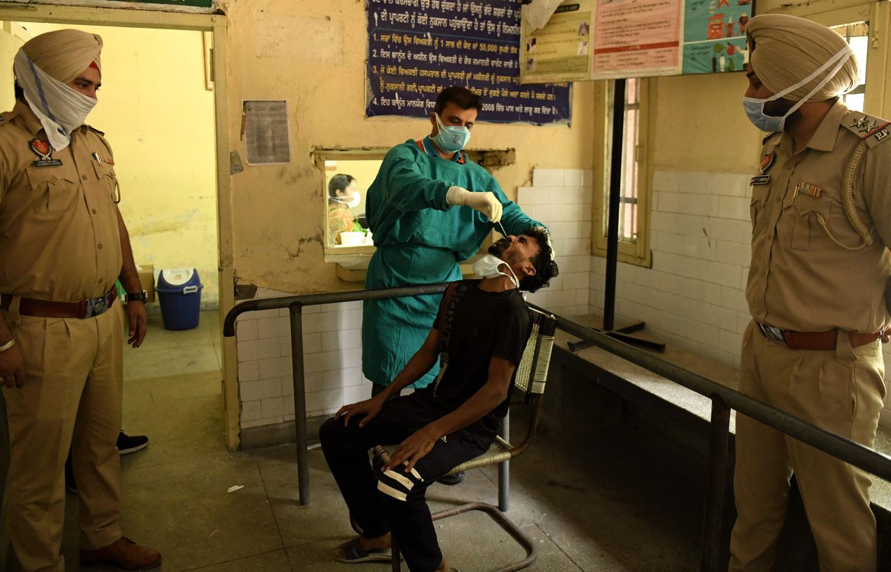 A health worker administers a Covid-19 test on the outskirts of Amritsar on May 3. Police in rural areas launched a free cab service for villagers so they could get tested and vaccinated.