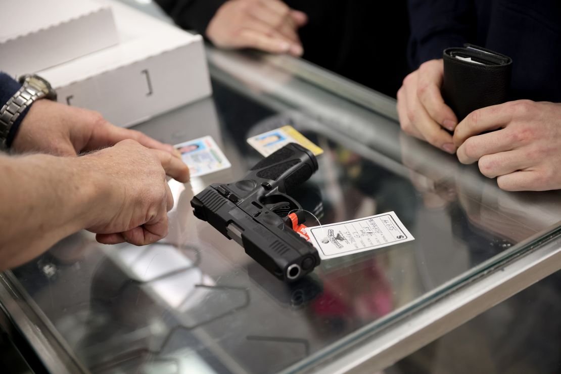 A customer purchases a gun at Freddie Bear Sports on April 08, 2021 in Tinley Park, Illinois.