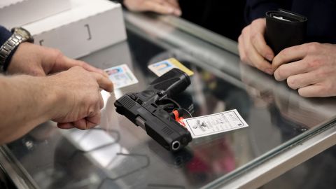 A customer purchases a gun at Freddie Bear Sports on April 08, 2021 in Tinley Park, Illinois.