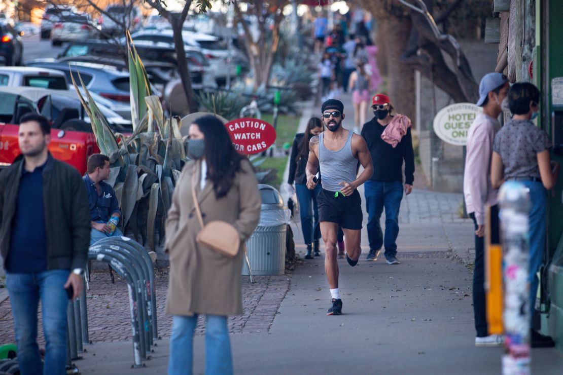 Pedestrians walk  in Austin before Texas Gov. Greg Abbott ended the state's mask mandate in March.  