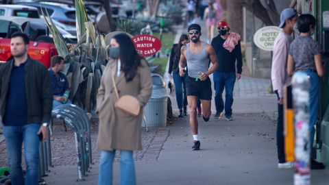 Pedestrians walk in Austin before Texas Gov. Greg Abbott ended the state's mask mandate in March.