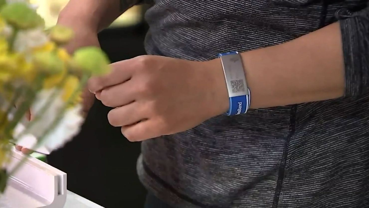 Employees at El Merkury in Philadelphia wear bands proving they have been vaccinated for Covid-19.