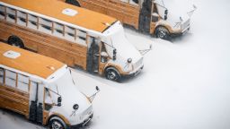 School buses are covered in snow during a snowstorm, Monday, Feb. 1, 2021, in Brooklyn, New York. (AP Photo/Wong Maye-E)