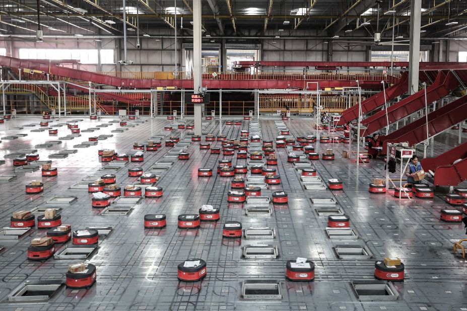 Robots sort packages at a warehouse run by JD.com -- one of China's largest e-commerce firms, in Wuhan, China, ahead of the annual Singles Day online shopping bonanza, in 2019.