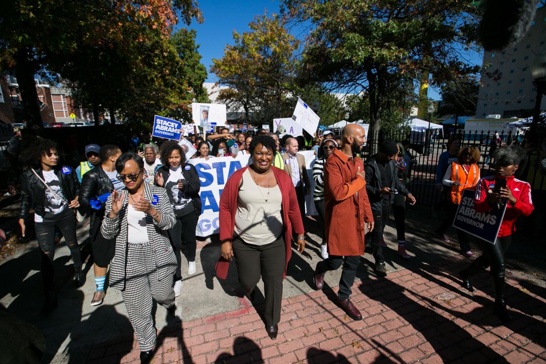 Then-Georgia Democratic gubernatorial candidate Stacey Abrams and Grammy-winning artist Common lead voters during a "souls to the polls" event in downtown Atlanta on October 28, 2018.