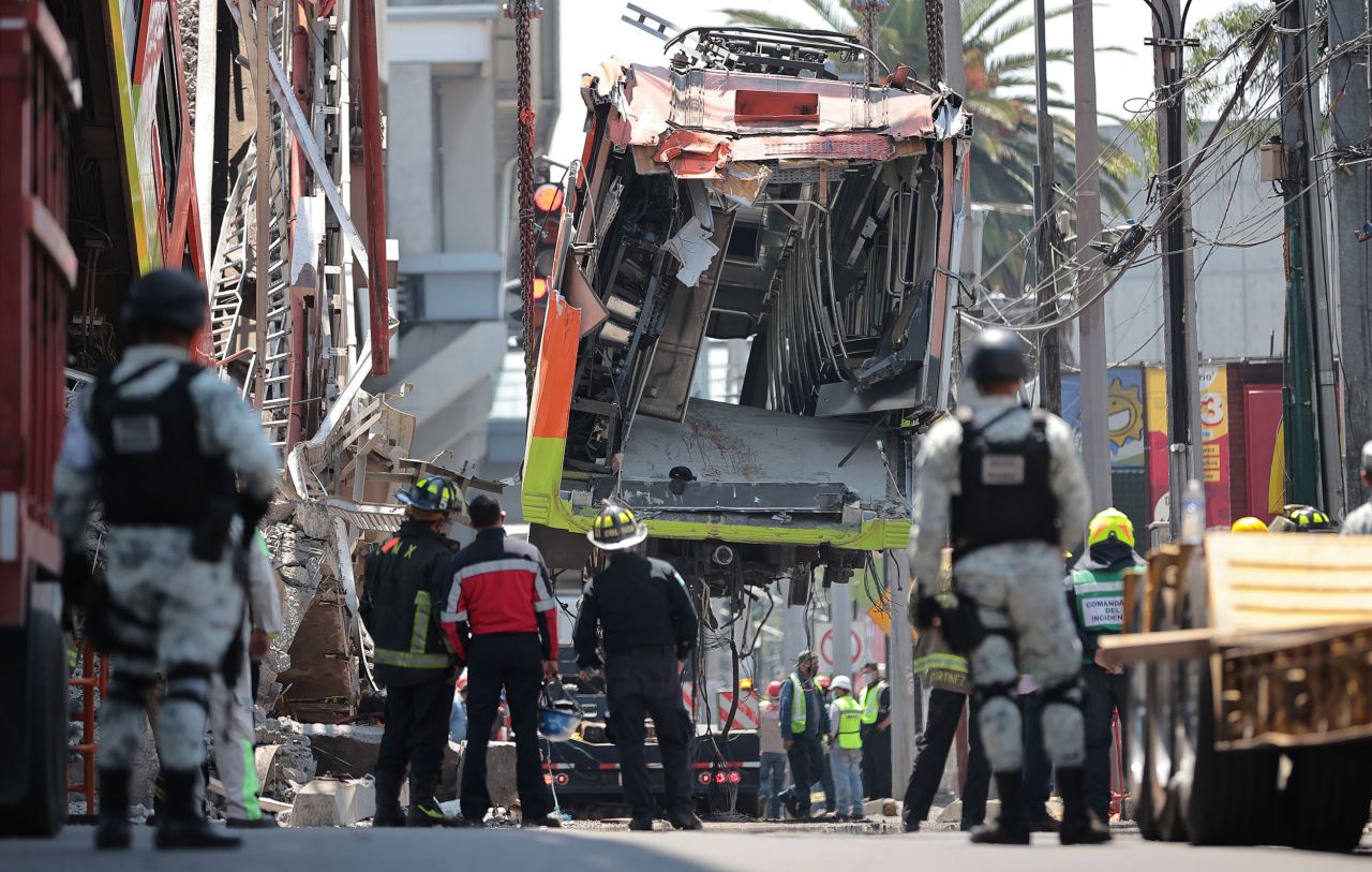 People work to remove debris Tuesday, May 4, after an overpass carrying a subway train collapsed in Mexico City the night before.