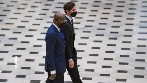 Sens. Raphael Warnock and Jon Ossoff of Georgia walk toward the House Chamber in National Statuary Hall of the US Capitol on April 28, 2021.