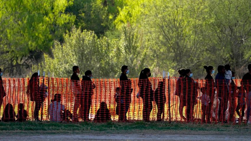 Migrants are seen in custody at a U.S. Customs and Border Protection processing area under the Anzalduas International Bridge, Friday, March 19, 2021, in Mission, Texas. A surge of migrants on the Southwest border has the Biden administration on the defensive. The head of Homeland Security acknowledged the severity of the problem Tuesday but insisted it's under control and said he won't revive a Trump-era practice of immediately expelling teens and children. An official says U.S. authorities encountered nearly double the number children traveling alone across the Mexican border in one day this week than on an average day last month. (AP Photo/Julio Cortez)