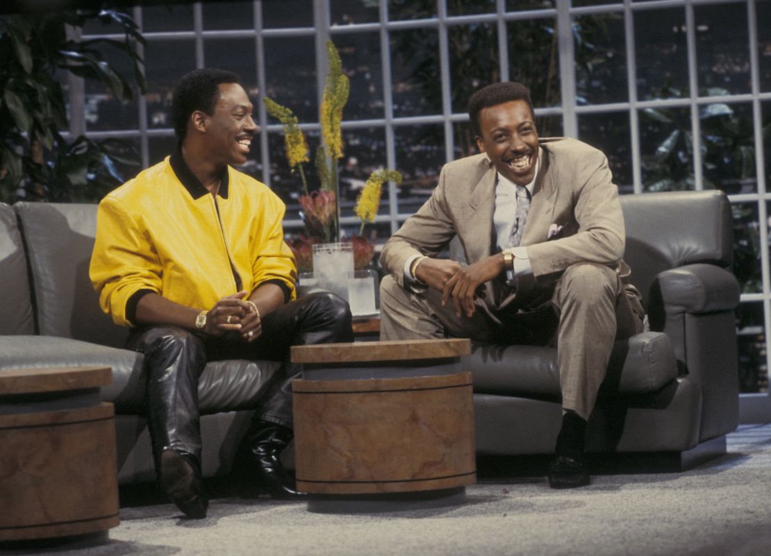 Arsenio Hall (here with Eddie Murphy) shook up late night as the first Black host -- and notably did away the desk format.