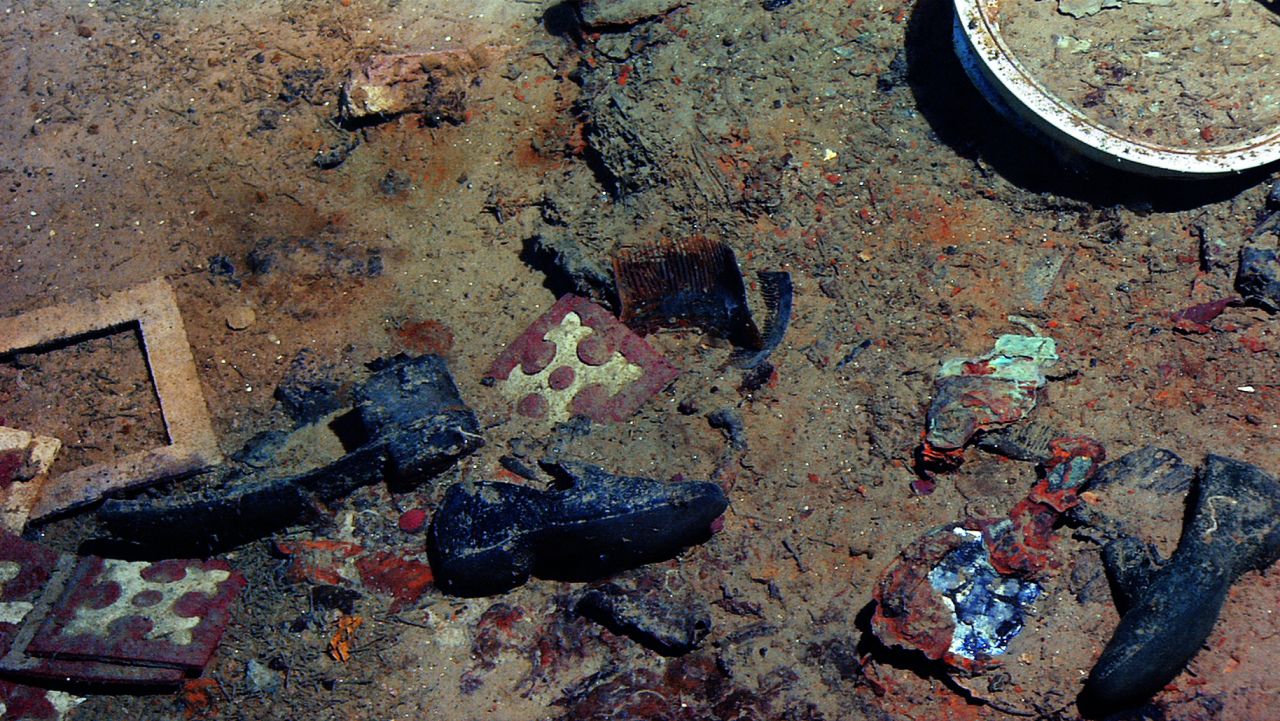 <strong>Chilling footage: </strong>"Two sizes of shoes, a hand mirror, and a comb evoke a scene. I keep imagining a mother combing her daughter's hair, unaware of their tragic future," Ballard writes in reference to this incredible inside of the wreck.