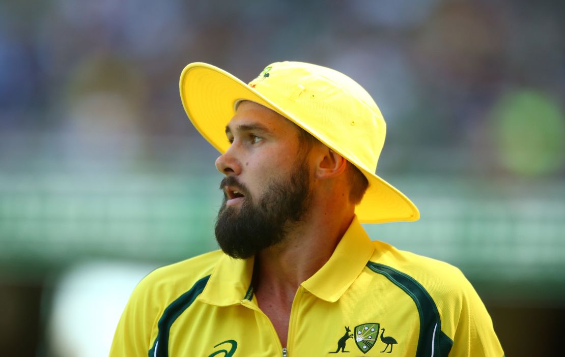 Kane Richardson of Australia looks on wearing a yellow floppy hat during game three of the One Day International Series between Australia and India at the Melbourne Cricket Ground on January 17, 2016 in Melbourne, Australia. 
