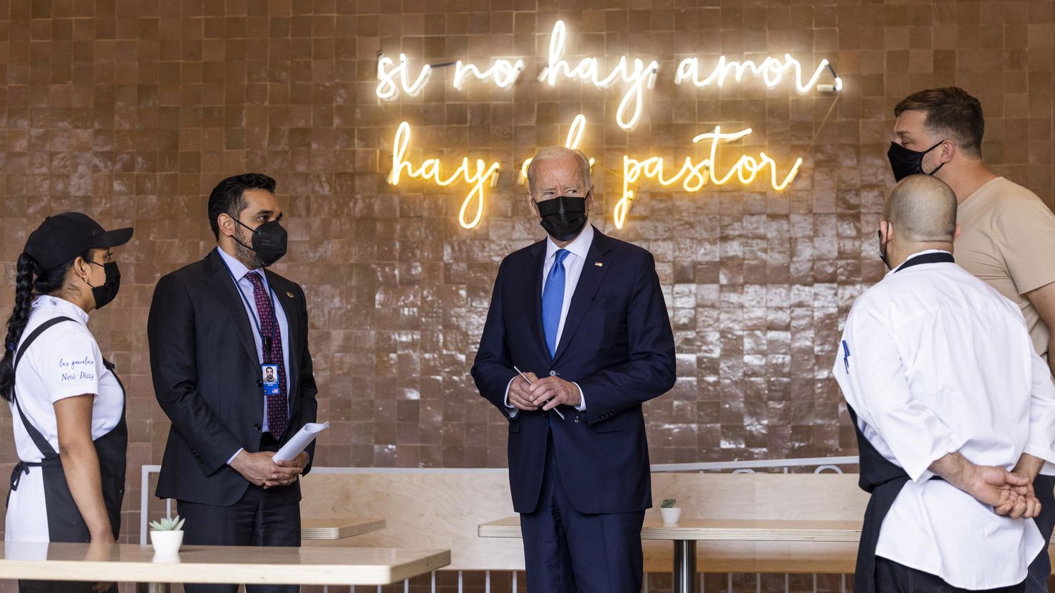 U.S. President Joe Biden, center, wears a protective mask while speaking to employees at Las Gemelas restaurant in Washington, D.C., U.S., on Wednesday, May 5, 2021. Biden visited the restaurant owned in part by Mexican immigrants to highlight $28.6 billion in federal aid for restaurants that struggled during the pandemic. 