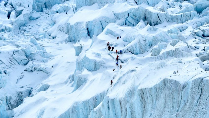 TOPSHOT - In this photograph taken on May 2, 2021 mountaineers trek along the Khumbu glacier near Everest base camp in the Mount Everest region of Solukhumbu district, some 140 km northeast of Nepal's capital Kathmandu. (Photo by PRAKASH MATHEMA / AFP) (Photo by PRAKASH MATHEMA/AFP via Getty Images)