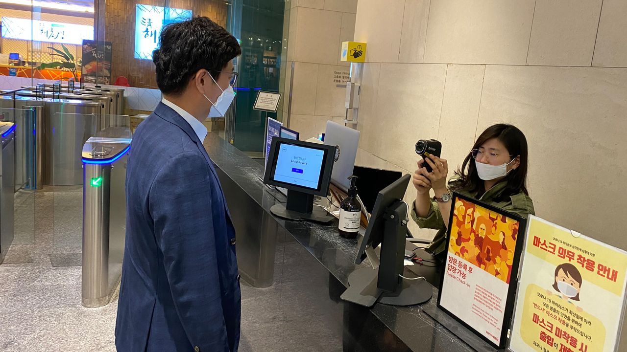 An employee gets a temperature screening in Seoul, South Korea.