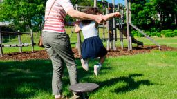 Illustration picture shows an adult holding a girl playing in a playground in Brussels, Wednesday 27 May 2020. From Today, municipalities can re-open the play areas for children under twelf. Belgium is in its eleventh week of confinement in the ongoing corona virus crisis and the second week of the phase 2 of the deconfinement. The National Security Council has given the Go to the deconfinement in stages as developed by the Group of Experts for the Exit Strategy. BELGA PHOTO THIERRY ROGE (Photo by THIERRY ROGE/Belga/Sipa USA)(Sipa via AP Images)